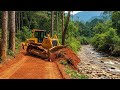 Heavy Bulldozer Working Hard to Clear Forest and Flatten Mountain Terrain