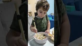 Boy holding chopsticks for the first time