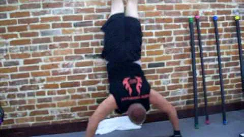 Bryan Archibald does handstand push-ups at Princet...