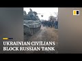 Civilians appear to block Russian tank from entering town in northern Ukraine