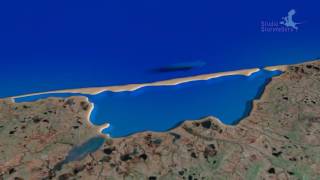 Longshore drift creating a spit and turning bay into lagoon