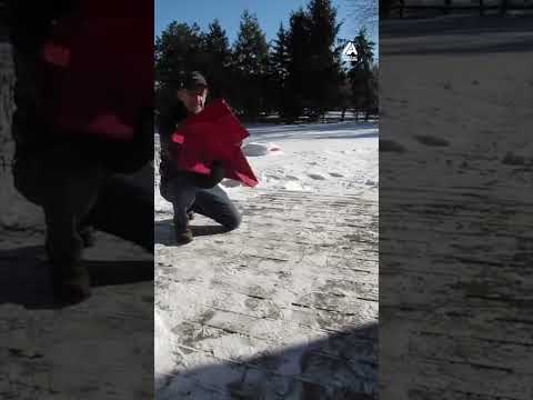 Man Folds Frozen T Shirt into Paper Airplane