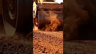 “#Slow-motion crushing of red #clay #soil under giant rollers #claysoil dust effects, warm #earthy