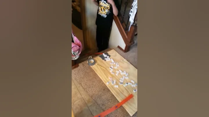 Dominoes: Car versus cup pyramid