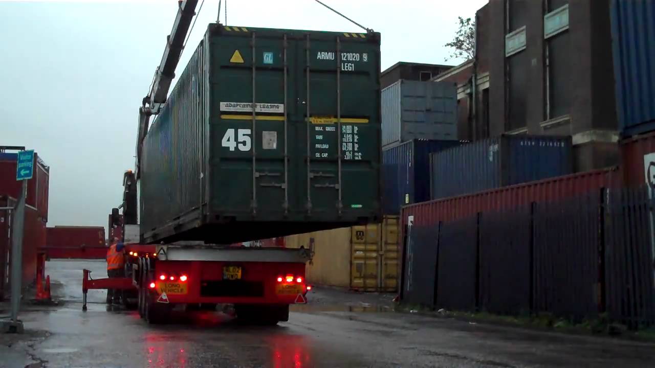 shipping container  for sale  being loaded on to delivery 