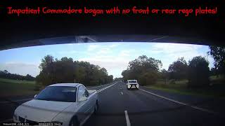Impatient bogan in a Commodore ute with no rego plates!