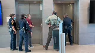 Woman escorted out by police for not wearing mask at school board meeting