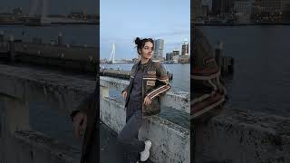 Blue hour hits different in Rotterdam. 🌃 Vintage leather, messy buns, and city lights. Just catchin