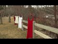 Red and White Dresses Line Deschutes River in Bend Ukraine Solidarity Tribute
