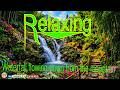 Waterfall flowing down from the mountain /Sun Relax4k