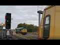 Güterzug: Begegnung einer Diesellok Class 66 mit Kieszug mit einer Ring-S-Bahn in Berlin-Tempelhof