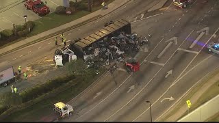 Tractor trailer overturns, spilling car parts on Jimmy Carter Blvd