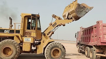 caterpillar 950F wheel Loader loading Sub grade material on the howo dupmtruck.