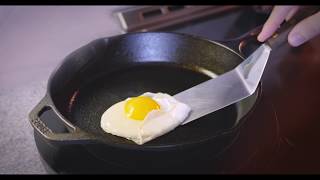 Flipping an egg on a Lodge skillet seasoned with Crisbee