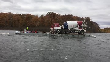 MN Permanent Docks - Clear...moving cement truck across lake on barge