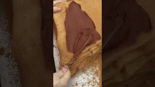 Spreading Chocolate Cream on Layered Cake