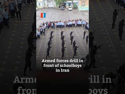Armed forces drill in front of schoolboys in Iran