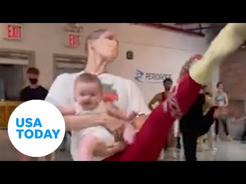 Ballet dancer holds her infant daughter while practicing in New York City | USA TODAY