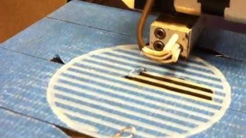 3D printer printing out a push-button