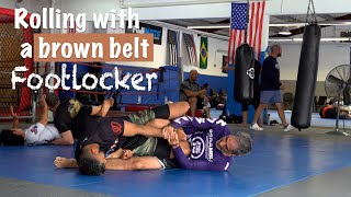 Purple belt rolling with brown belt leg locker