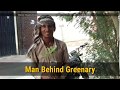 A man behind greenary  memon housing society