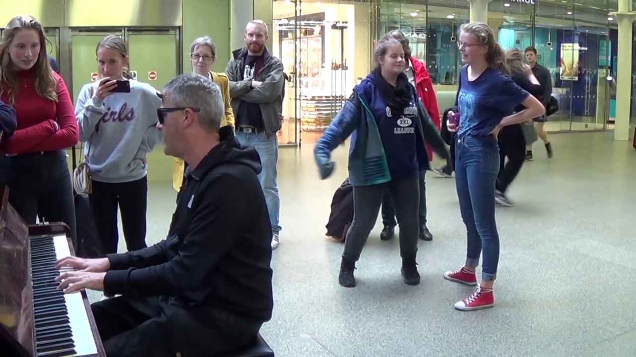 Actor On The Way To Theatre Approaches A Street Piano