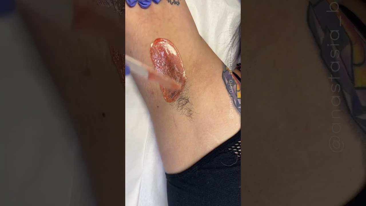 Professional underarm wax service on a first time client using coral hard wax formula from Starpil