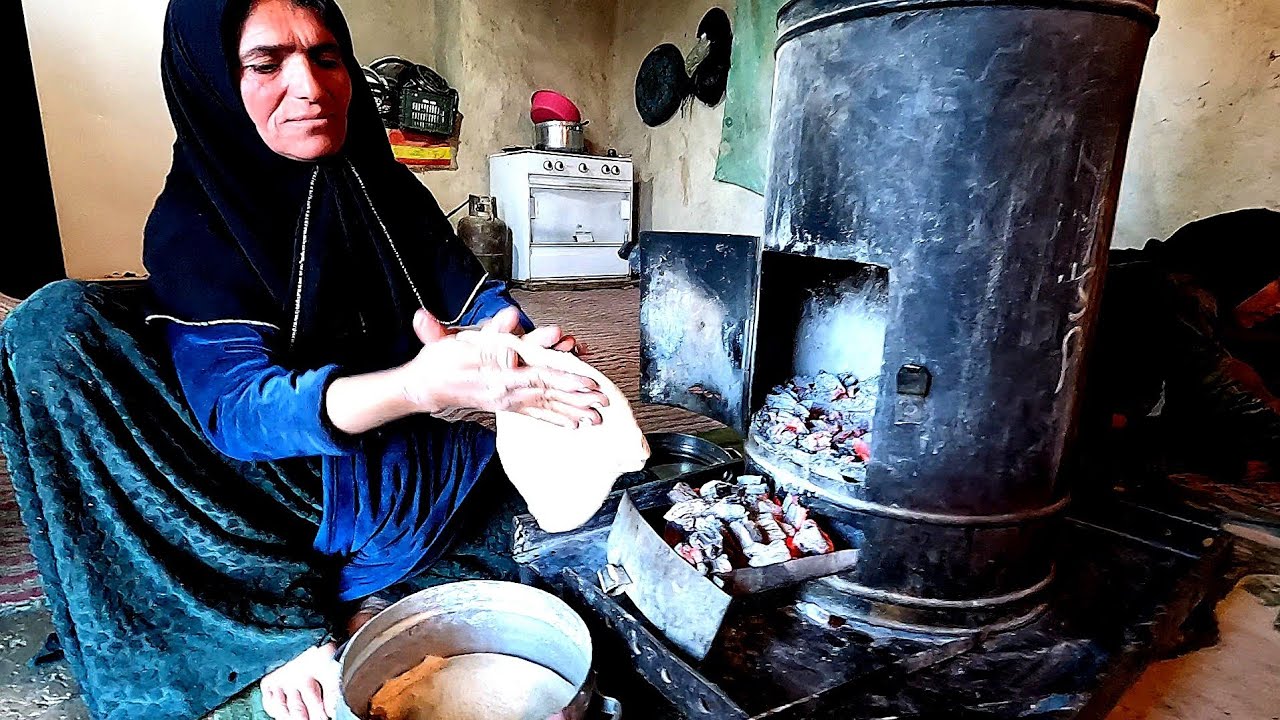 Cooking delicious cake in a woodfired oven by village mother with