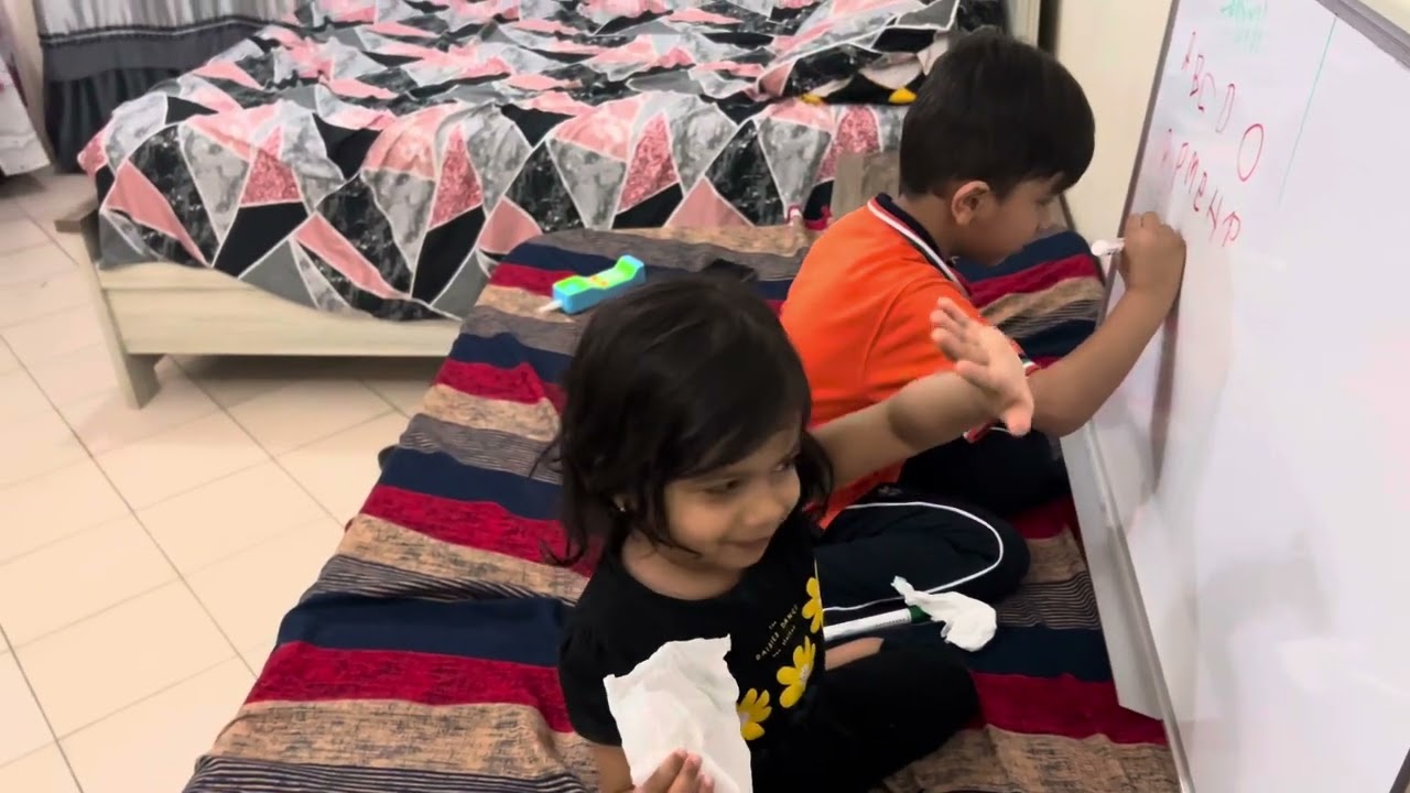 Hasni and meena writing in whiteboard 