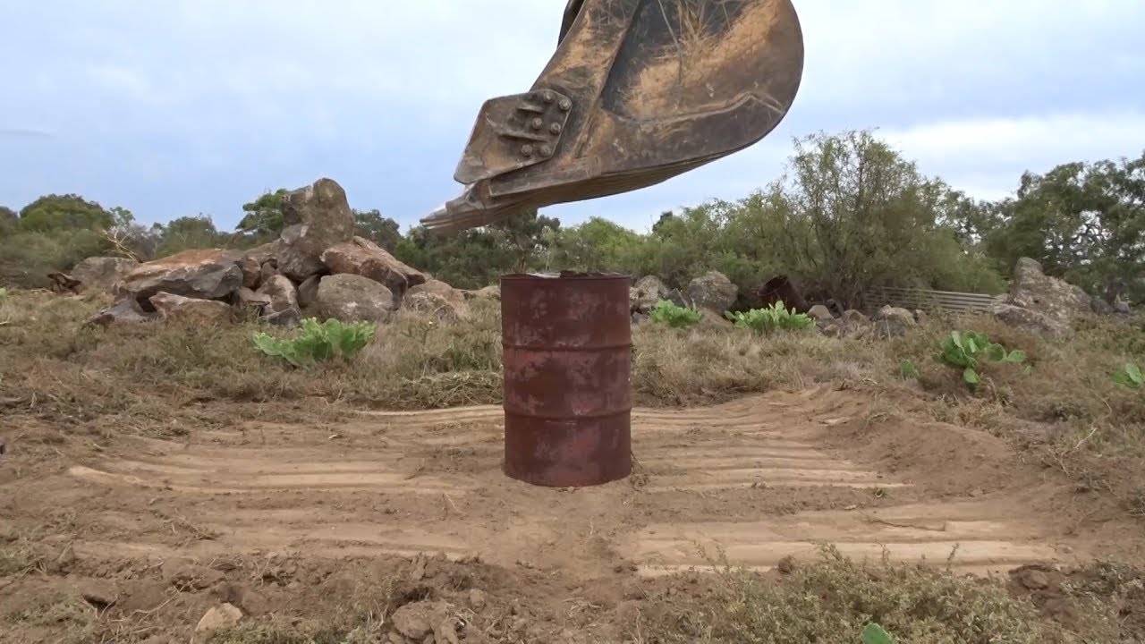 30 Ton Excavator Flattens 44 gallon drum
