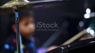 Blurry kid learning and play drum set in music room. The concept of musical instrument. 4K