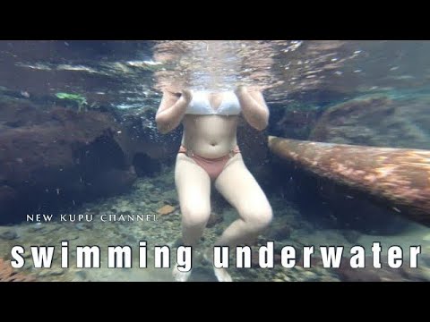 Swimming underwater in a spring waterfall