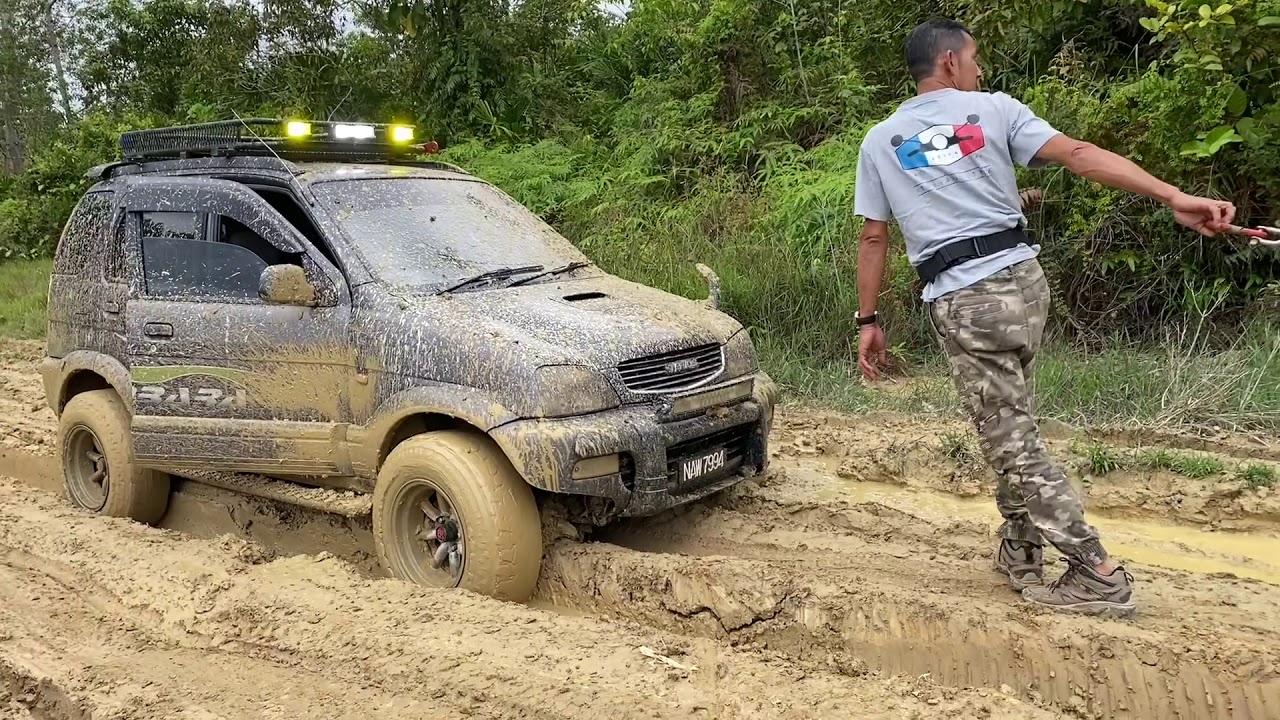4WD Kembara Terios and Kia Sportage negotiating muddy tropic terrain