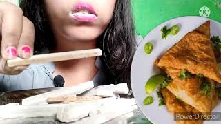 Eating samosa with spicy chutney