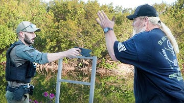 He has hand grenades and a .....