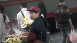 woman selling meat corn train station China