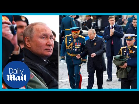 Vladimir Putin leaves Victory Day parade waving at admirers