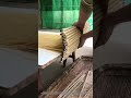 The process of taking handmade noodles off the drying rack