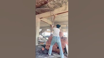 Workers hold shovels to remove formwork at the construction site