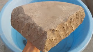 New video black dirt huge slab shapes crumbling in water satisfying