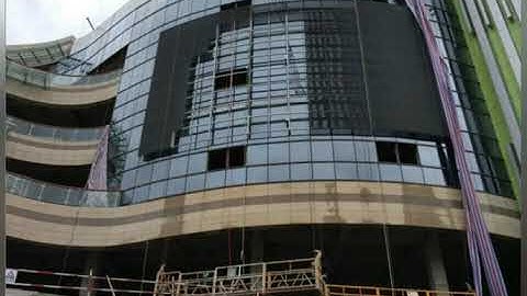 mesh transparent led screen installation on glass window building