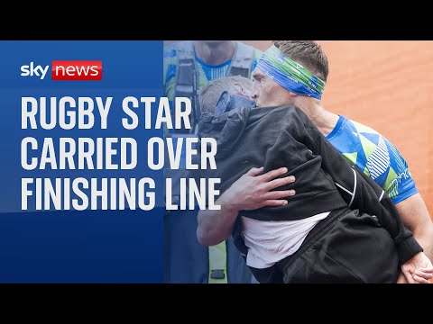 Emotional scenes as ex-rugby star Rob Burrow is carried over finish line at Leeds marathon