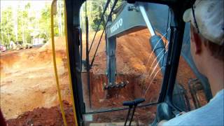 Excavator Cutting Basement Corner and Site Overview