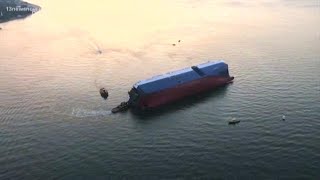 Rescue efforts continue on overturned cargo ship, four crew members unaccounted for