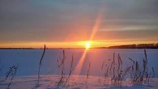 Cold winter sunset in snow field Amazing North of Ukraine