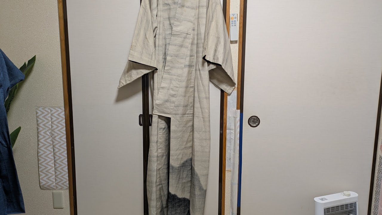 A kimono remade from Tsumugi silk with a patterned hem turned out