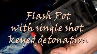 Flash pot with keyed detonation