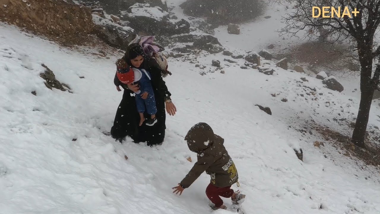 Mother and children embracing in the snow