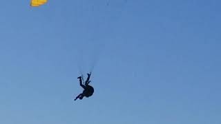 Paraglider flying with his feet (upside down)