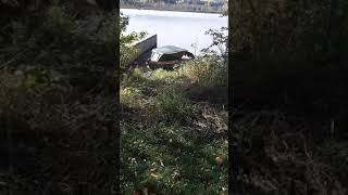 HOUSEBOAT DOCKED ON THE OTTAWA RIVER.